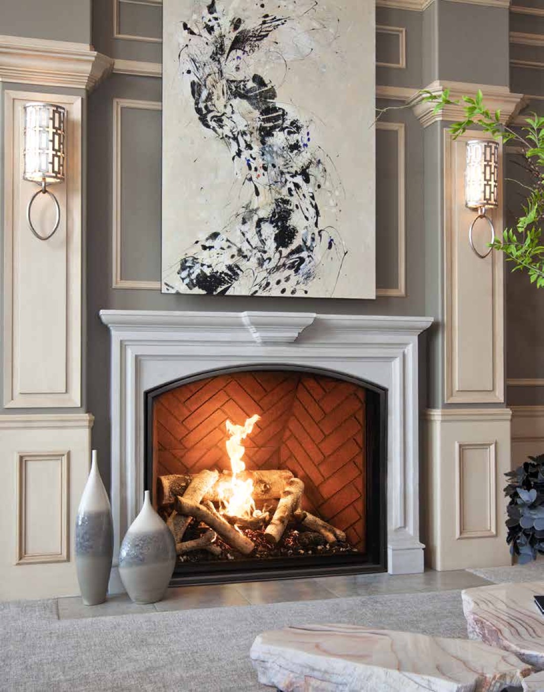 Traditional gas fireplace with birch logs in an elegant panelled room